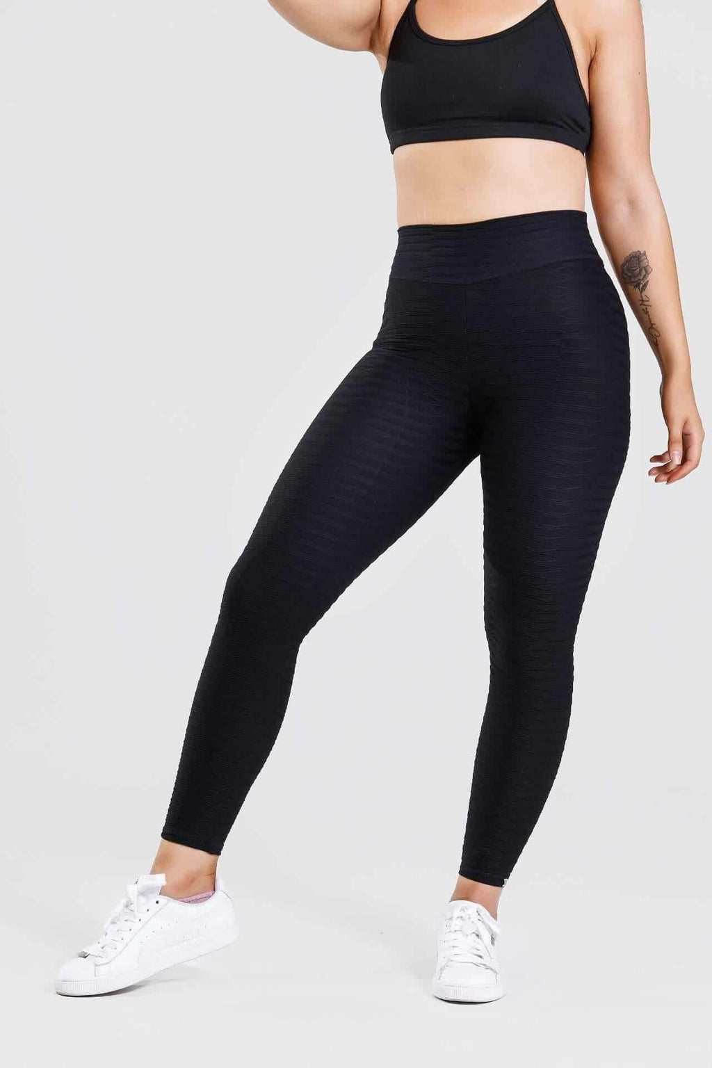 Front view, girl wearing adapt scrunch bum leggings in black