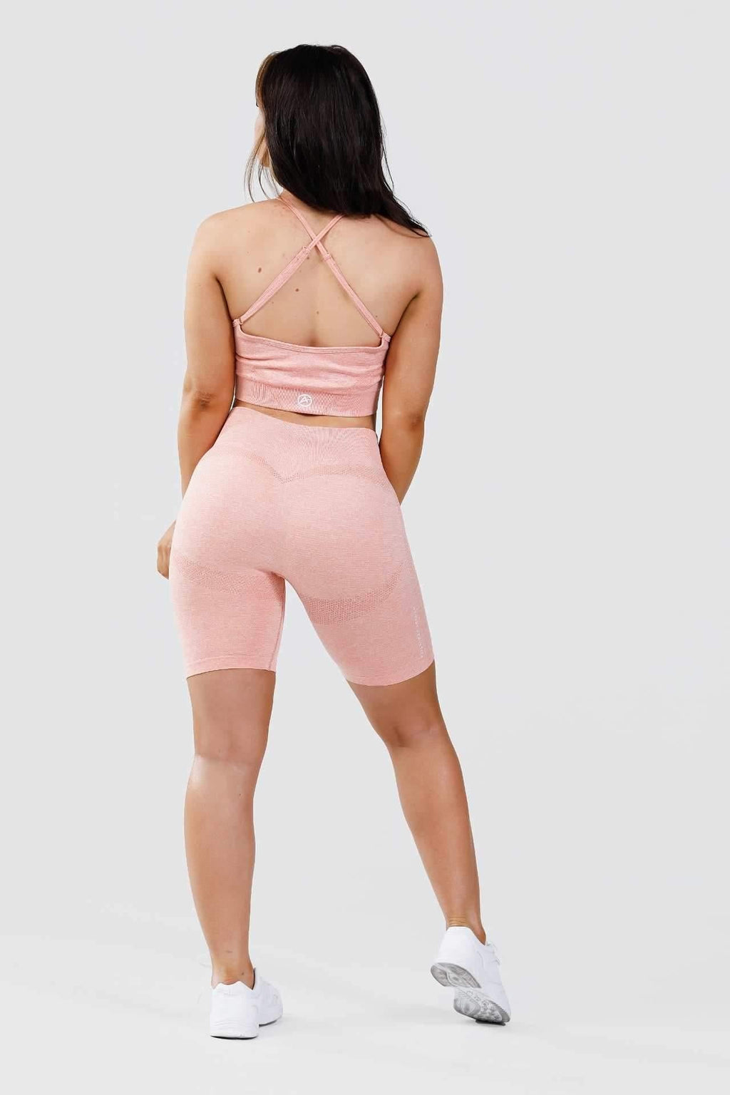 Girl back wearing calypso seamless set in pink marl