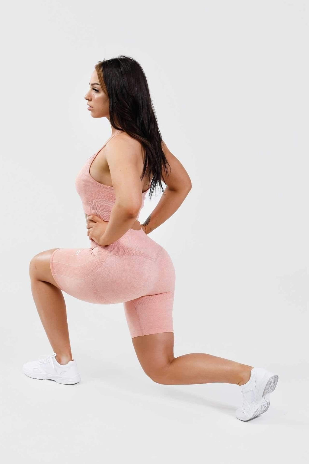 Girl lunging wearing pink calypso seamless set