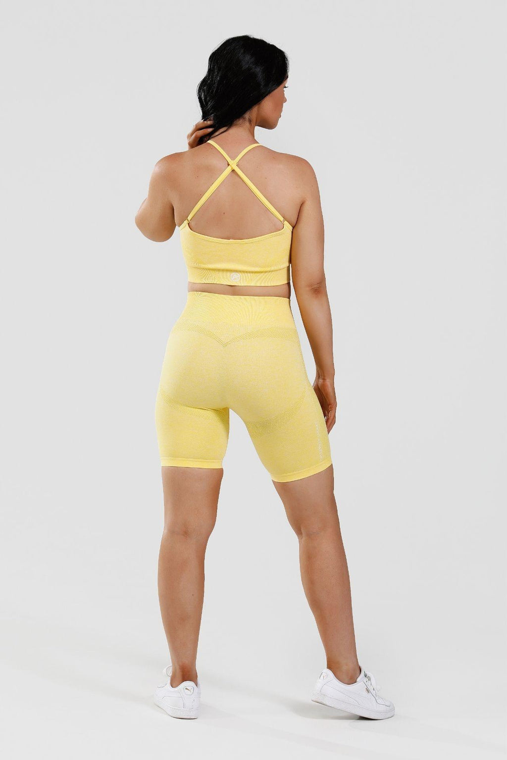 Girl wearing calypso seamless set yellow back
