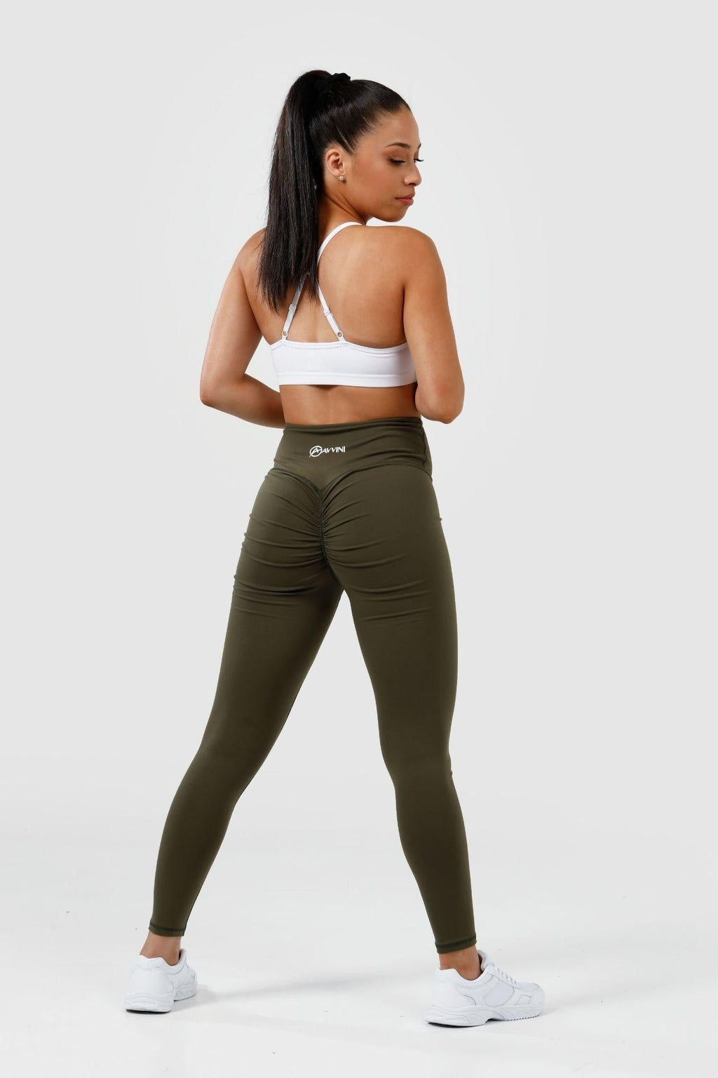 girl posing wearing olive scrunch bum leggings back