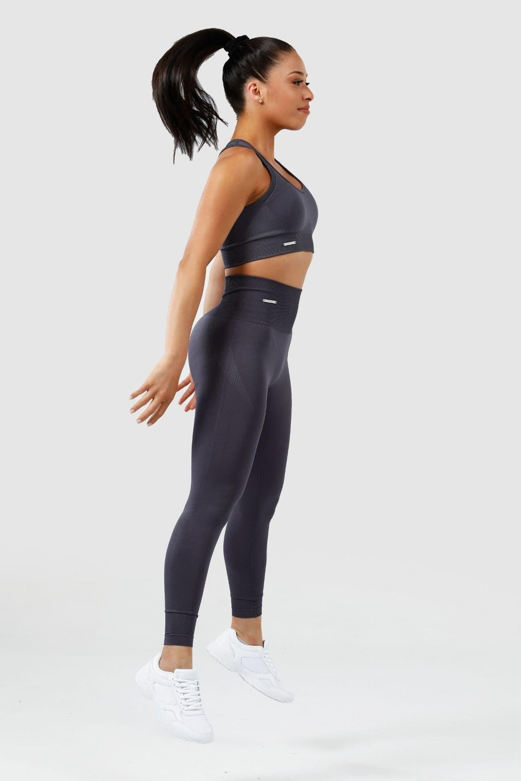 Girl jumping wearing charcoal invictus seamless set