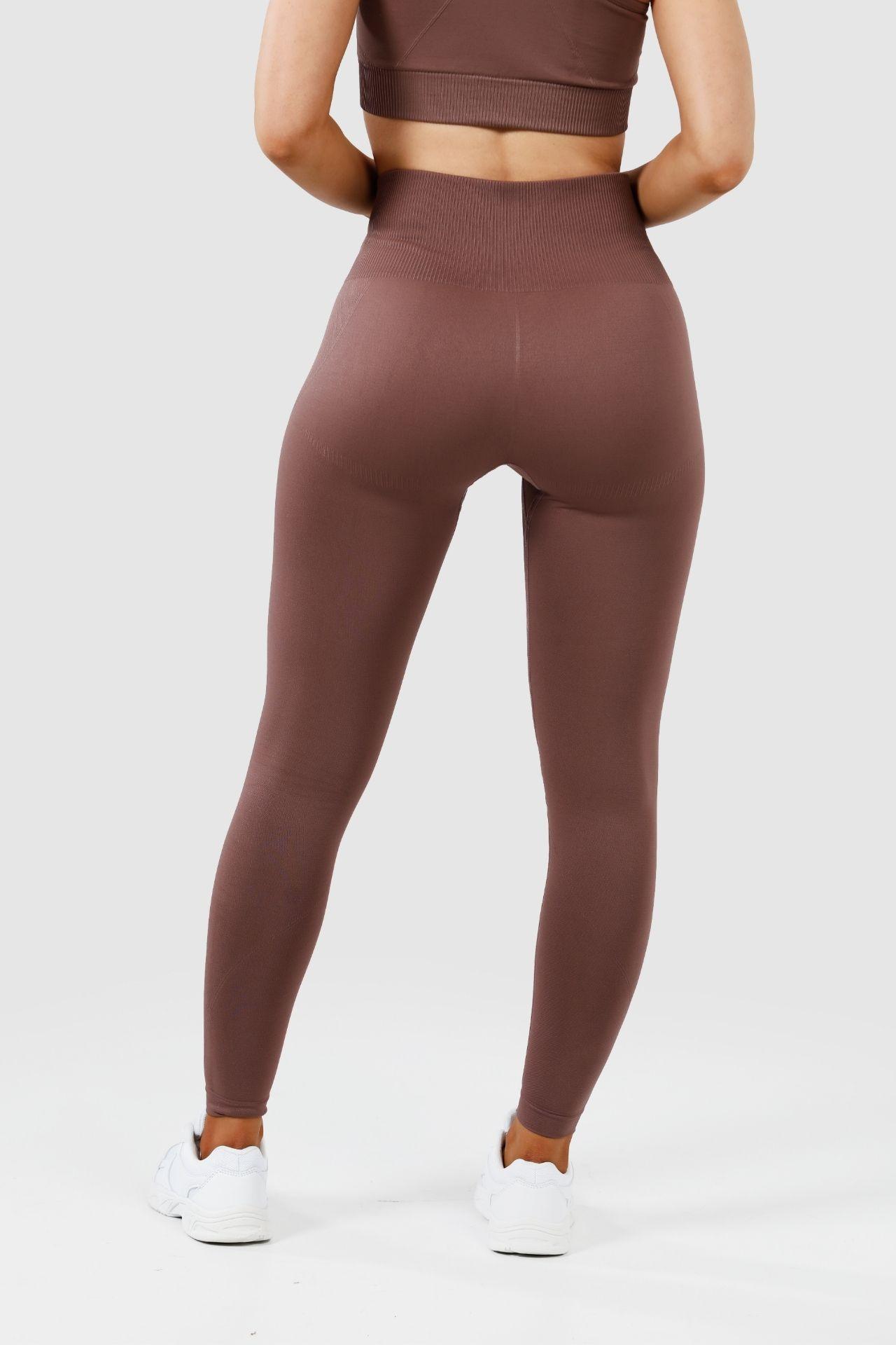 Girl wearing invictus seamless leggings mauve purple back