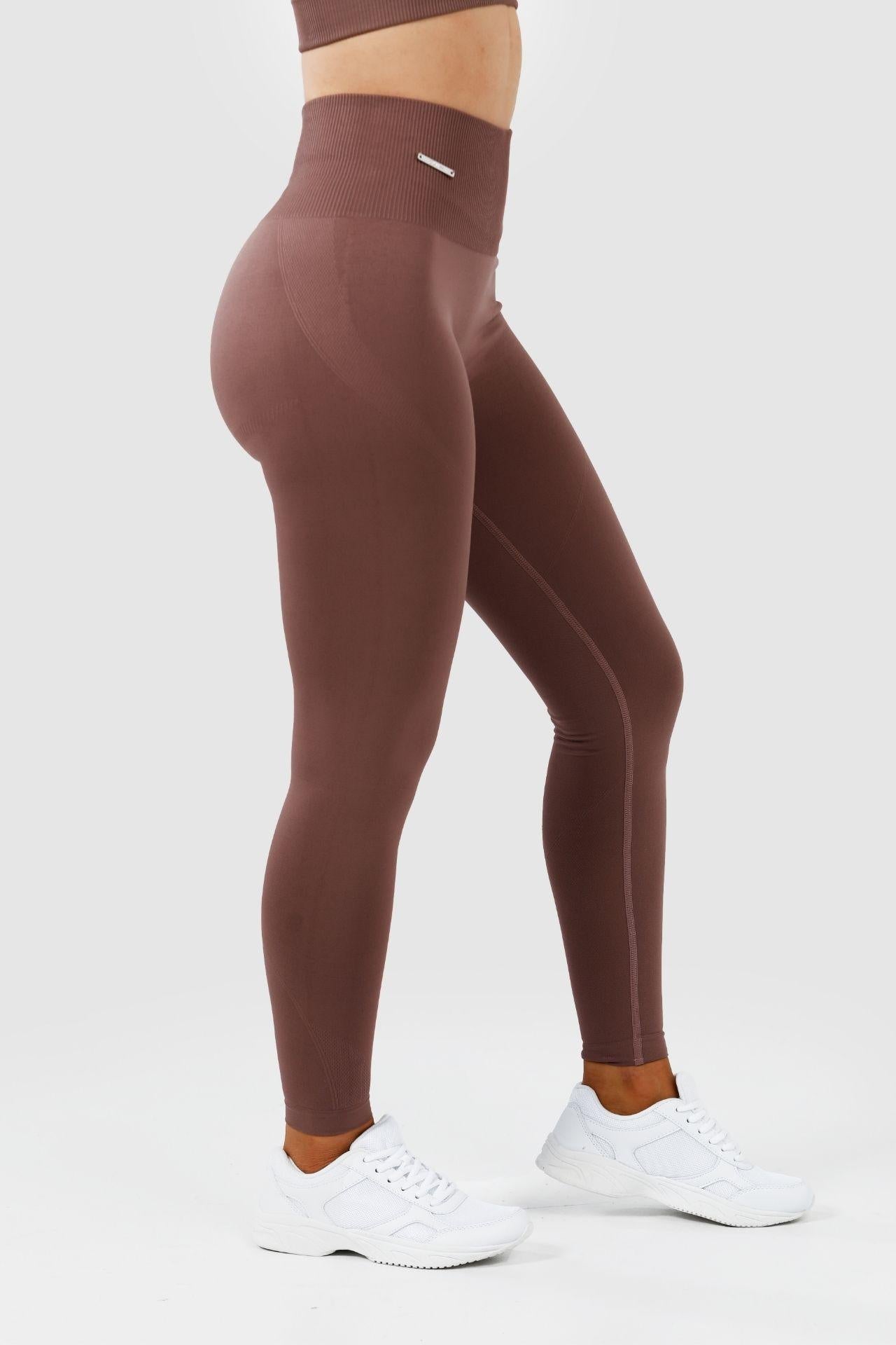 Side view girl wearing invictus seamless leggings in mauve purple