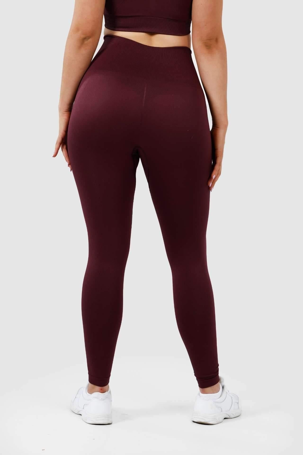 girl wearing invictus seamless leggings in plum purple back 