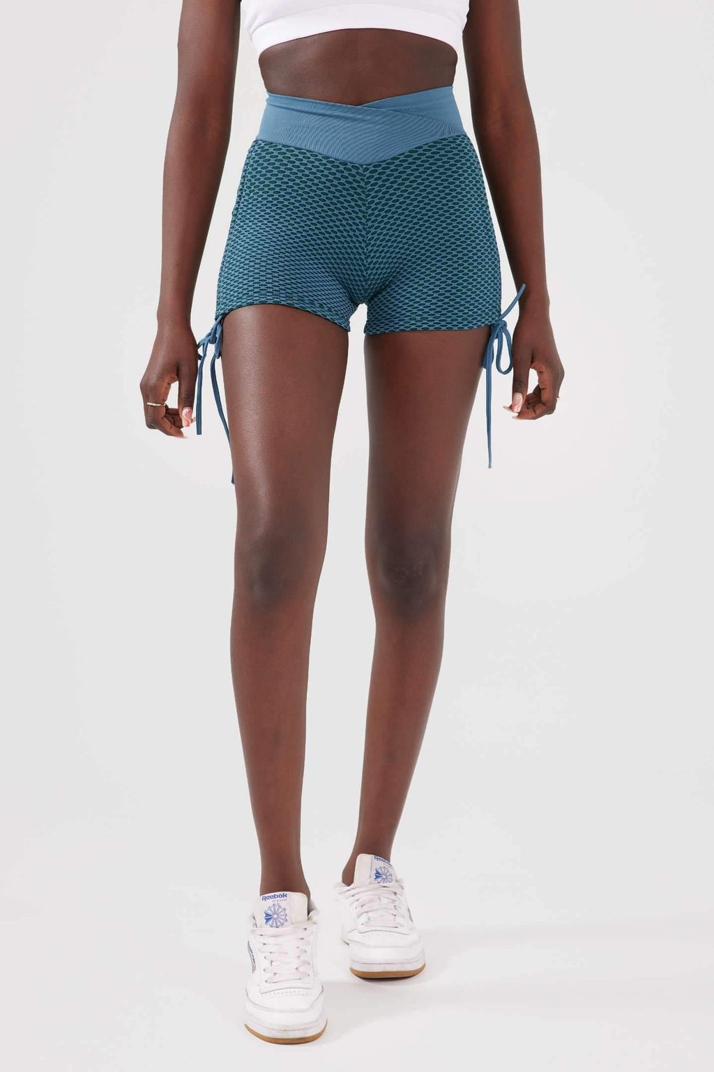 Girl wearing blue luna scrunch bum shorts front