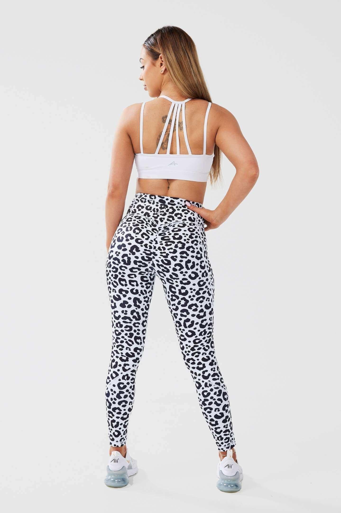 Girl posing hand on hip wearing leopard luxe scrunch bum pocket leggings and white classic top, back