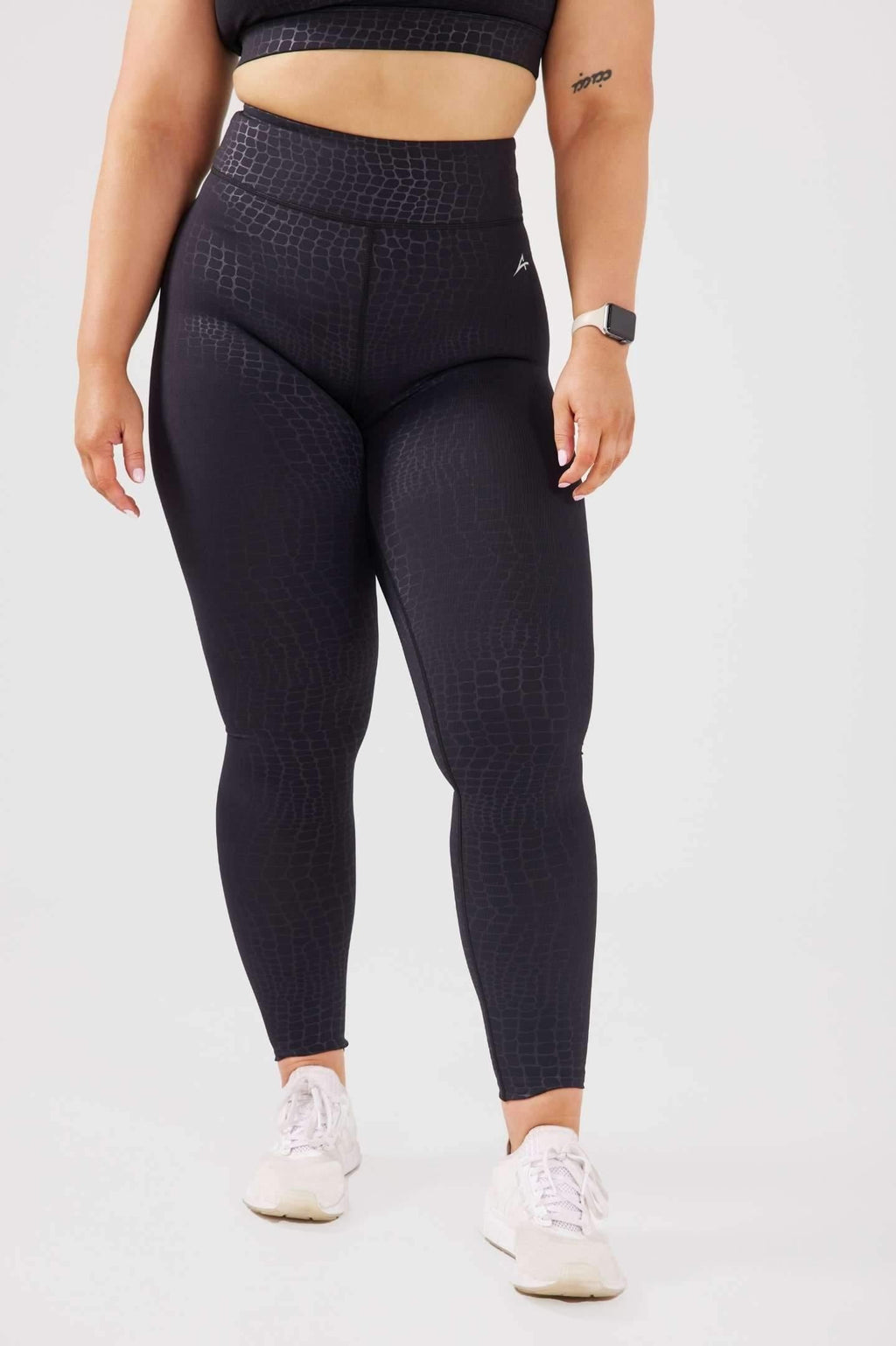 close up girl wearing luxe snake print leggings front