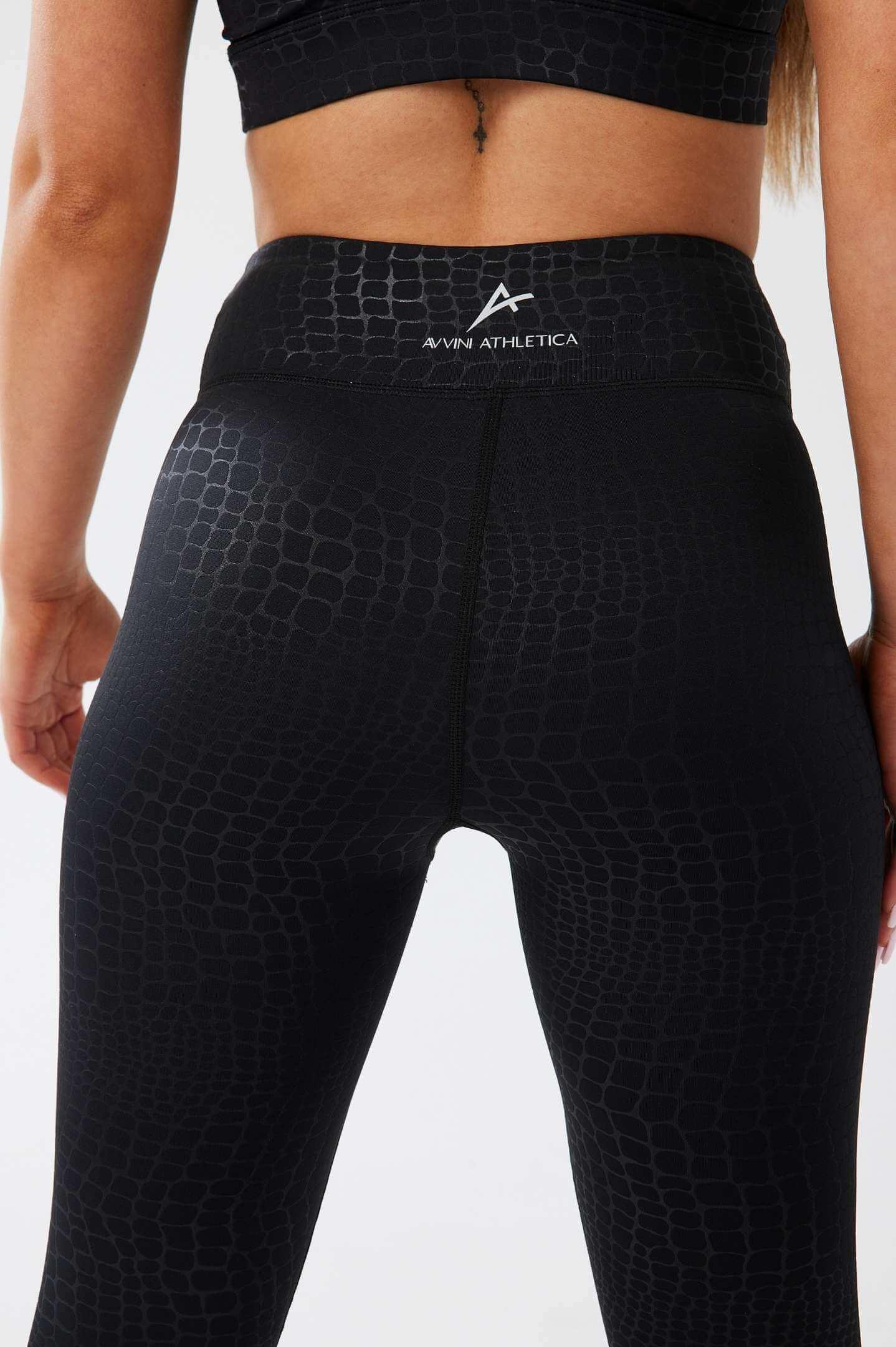 Close up girl wearing luxe snake print leggings back