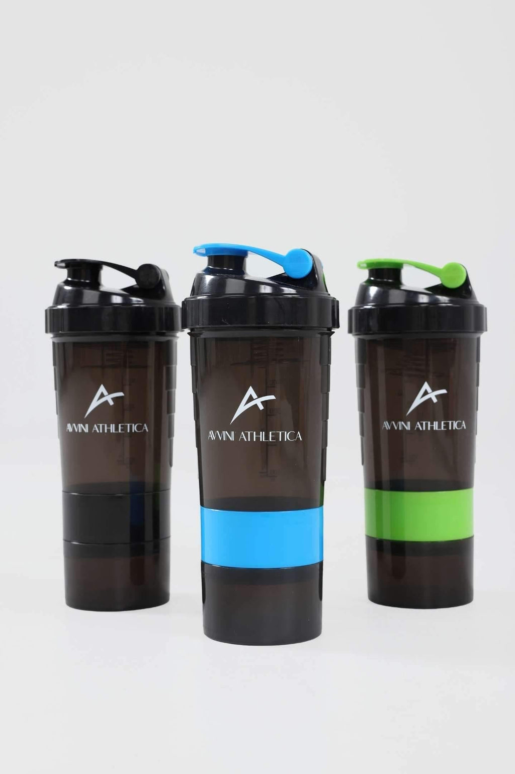 black, blue and green protein shaker bottle standing 